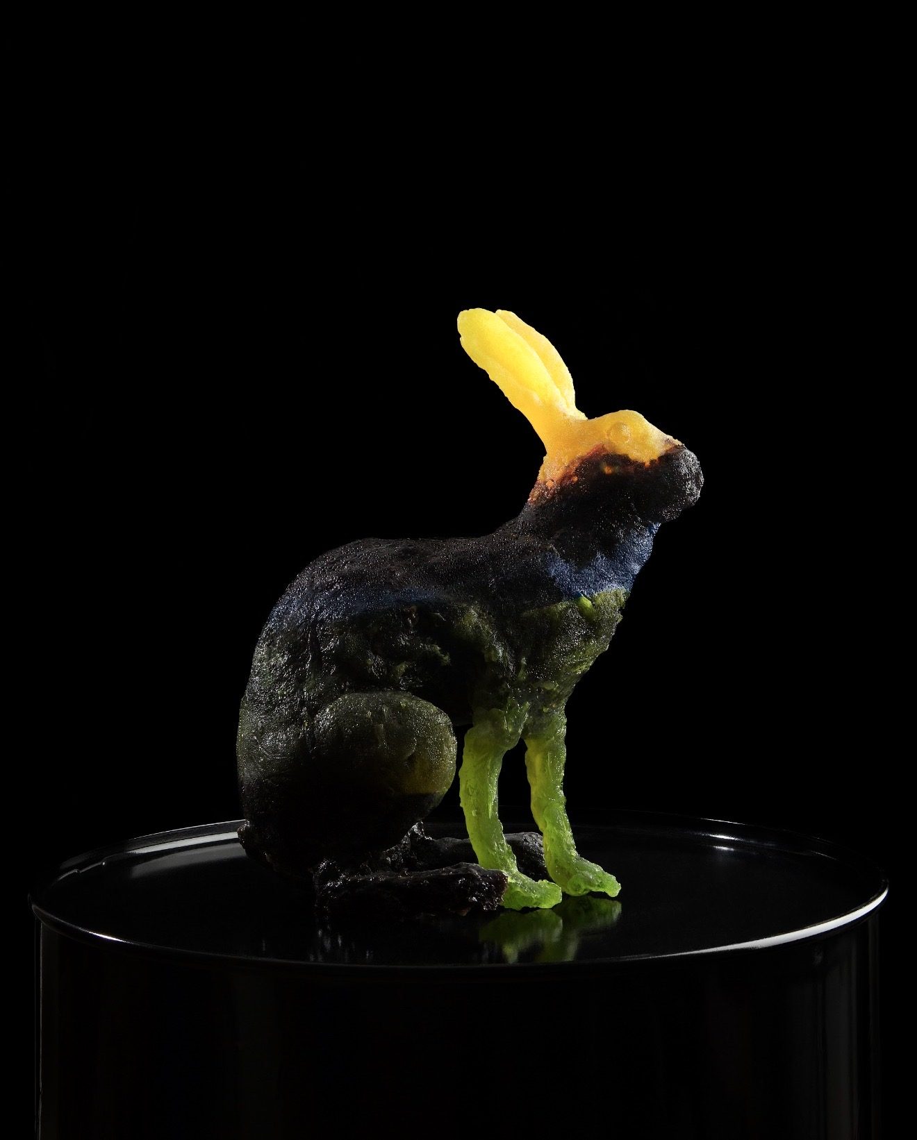 HOCUS-POCUS HARE, 2010 — hard-candy cast hare in yellow, dark blue, and green pigments on a reflective pedestal, by Hannes Bend