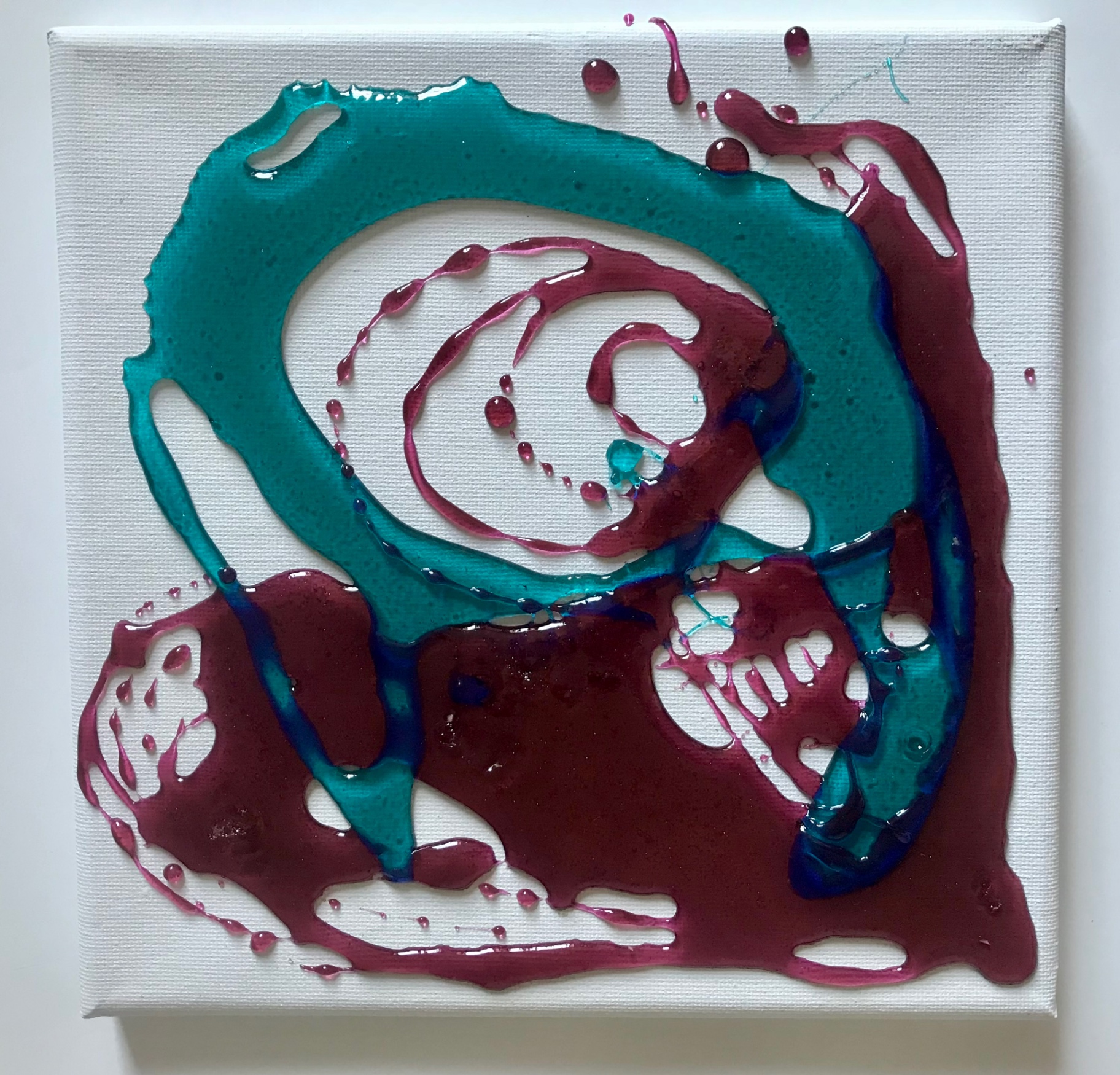 Candying canvas (teal & magenta), 2018 — poured teal and magenta candy in overlapping swirling forms on white canvas, by Hannes Bend