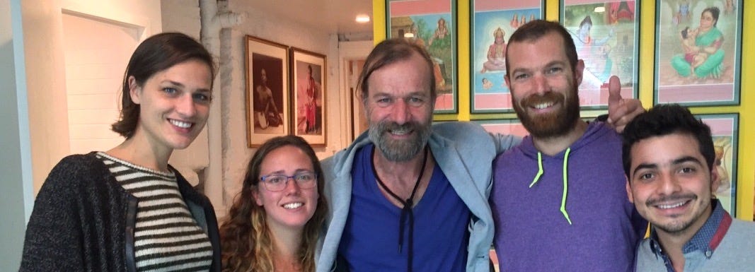 Wide group photograph of participants of the first New York workshop organized for Wim Hof and his team, seated and standing together in a studio space.