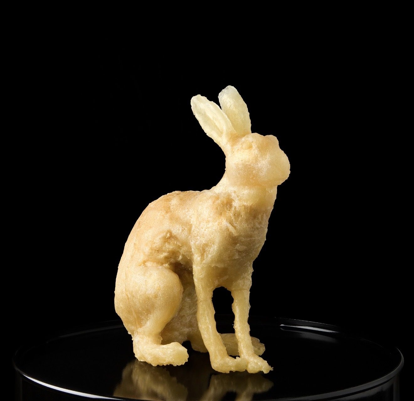 HOCUS-POCUS HARE, 2008 — hard-candy cast hare on a reflective pedestal, white cast, by Hannes Bend