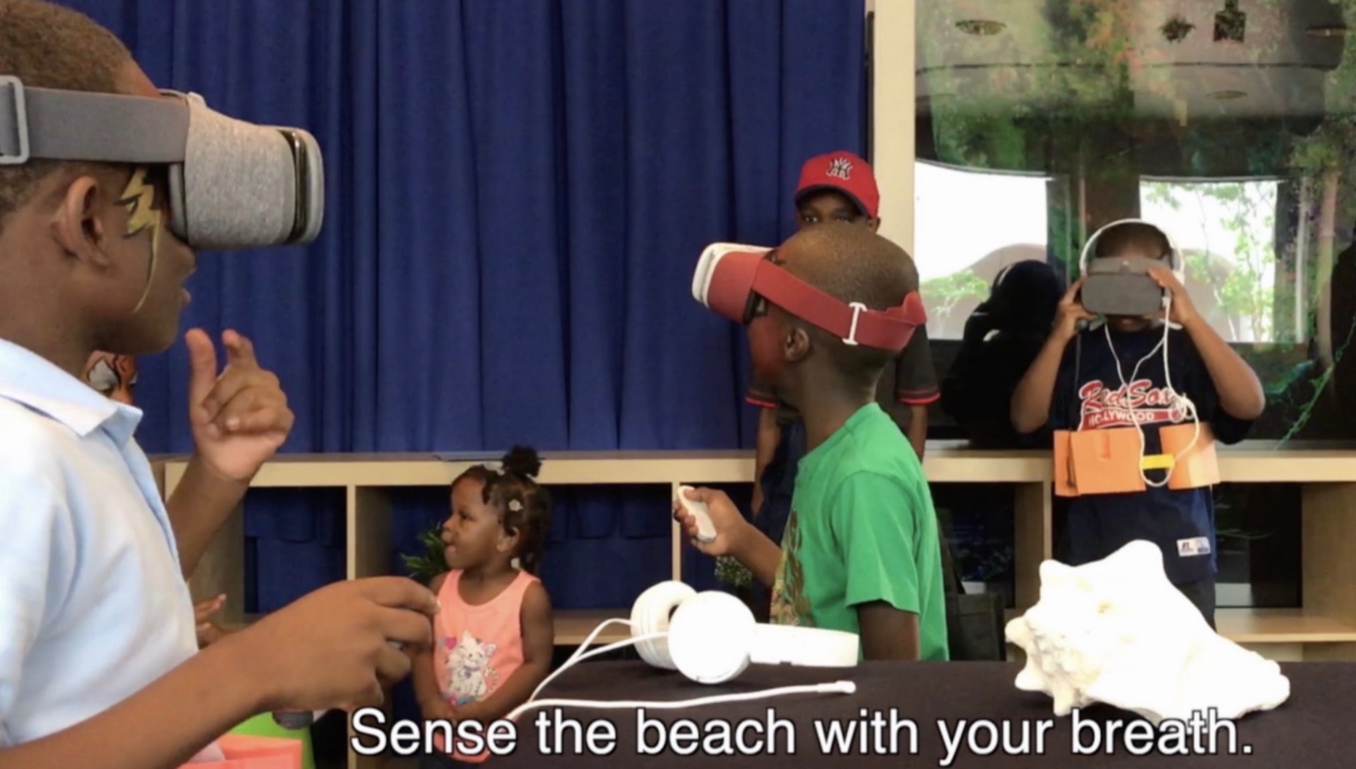Students using the SEAing Breath VR breath-biofeedback headset during a museum education program