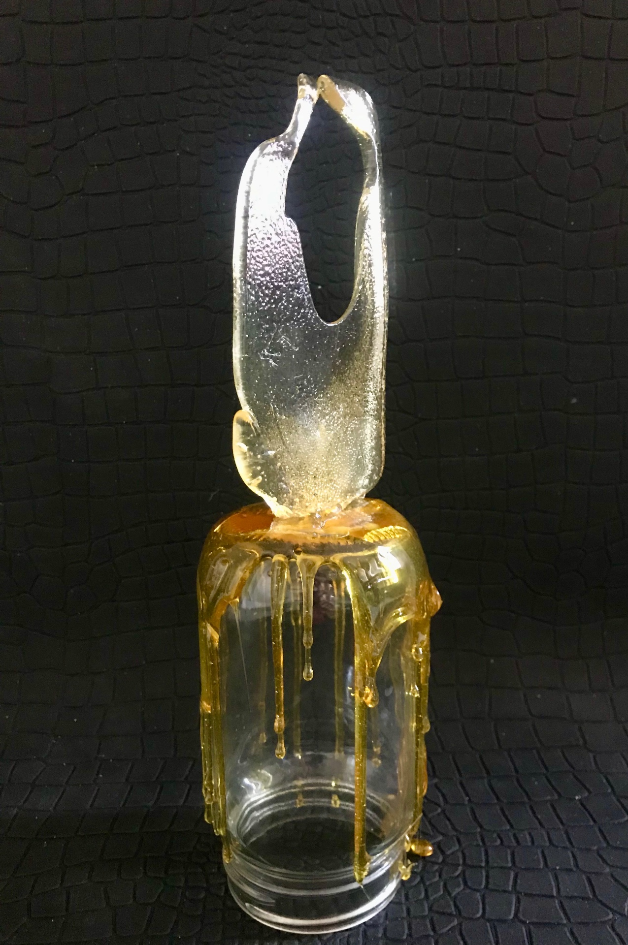 Cracked phone (amber), 2018 — candy cast in amber on a clear glass vessel with candy drips running down the sides, by Hannes Bend
