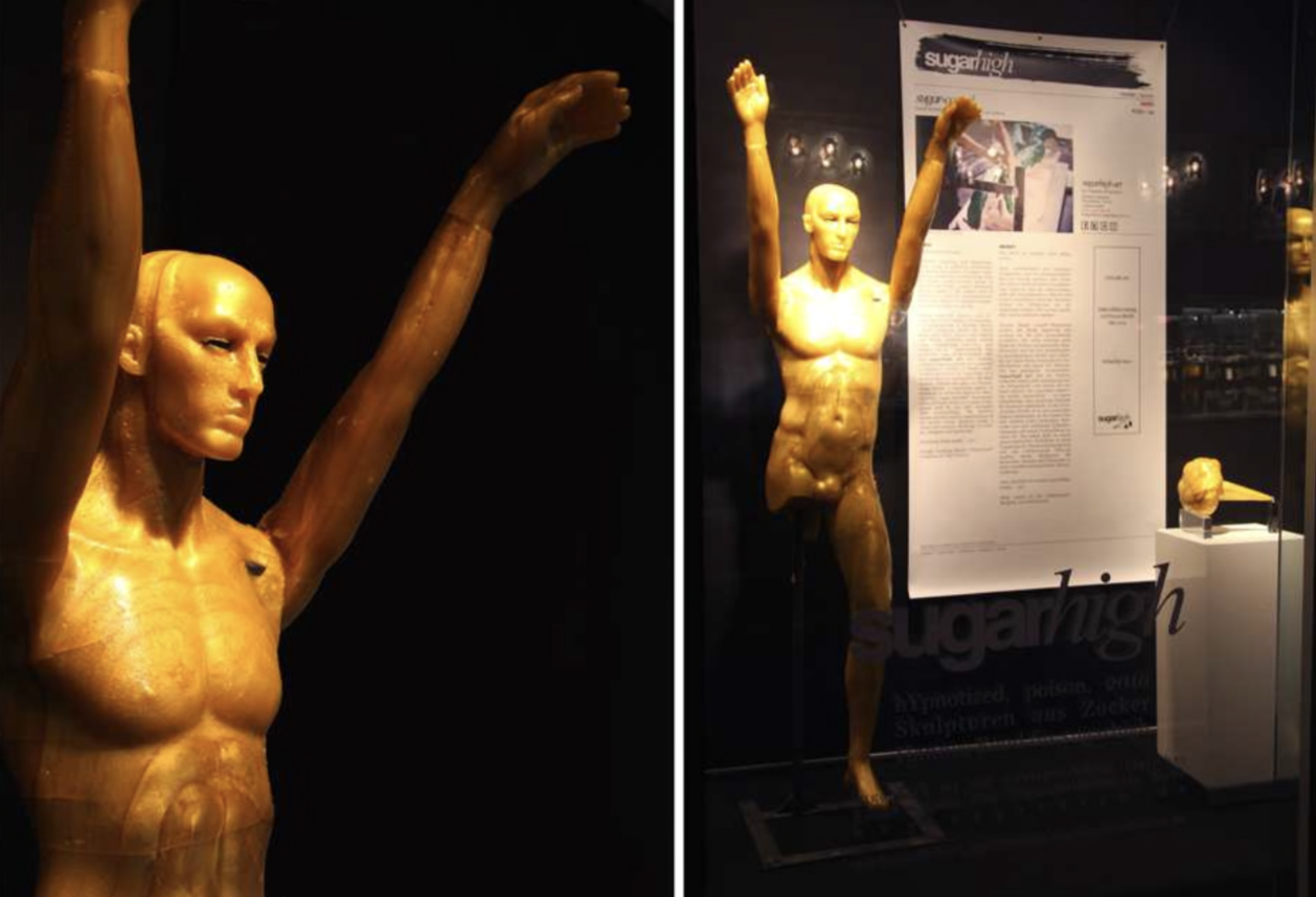 Hypnotized, 2010 — lifesize hard-candy cast figure with arms raised, installation view at the sugarhigh exhibition, by Hannes Bend