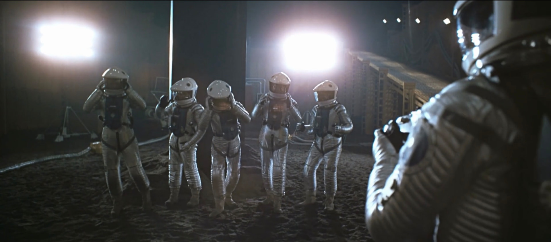 Astronauts gathered around the monolith on the lunar surface in Stanley Kubrick's 2001: A Space Odyssey (1968)