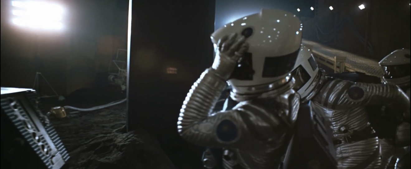 An astronaut reaching out to touch the surface of the monolith in Stanley Kubrick's 2001: A Space Odyssey (1968)