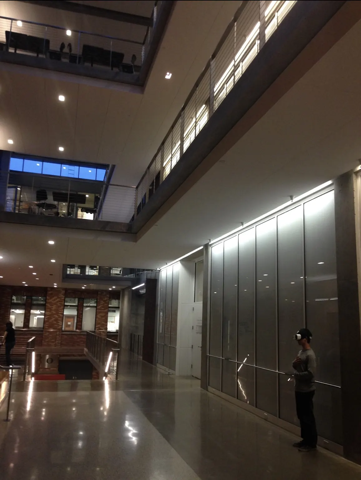 Wide interior view of the Lewis Integrative Science Building with a person wearing a VR headset.