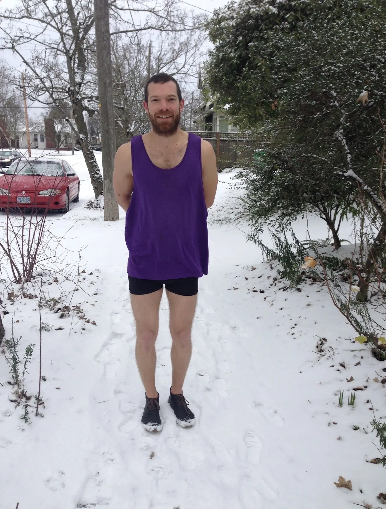 Hannes Bend practising cold exposure, standing in snow in a sleeveless top and shorts, Portland, Oregon, winter 2015.